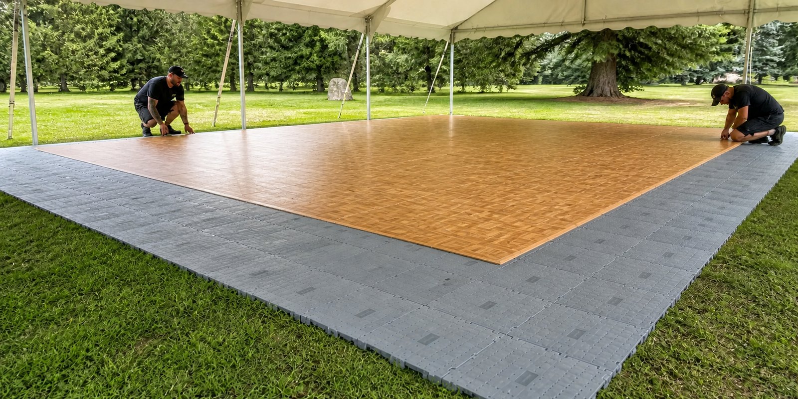 Oak dance floor with bevelled edges installed over grey temporary subfloor on grass
