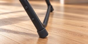 Protective foot on a folding-chair leg resting on a clean floor